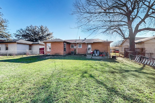 back of property featuring a yard and central AC unit