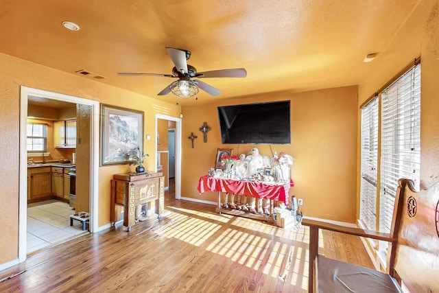 sitting room featuring ceiling fan and light hardwood / wood-style floors