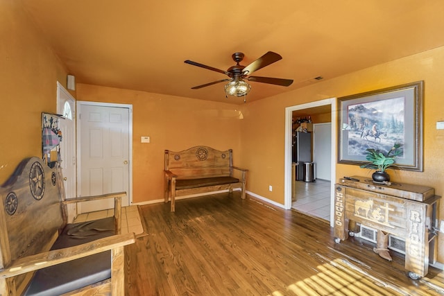 living area with hardwood / wood-style flooring and ceiling fan