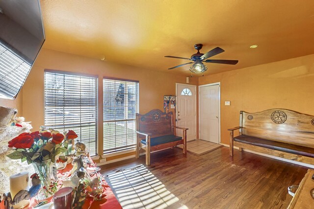 sitting room with hardwood / wood-style flooring and ceiling fan