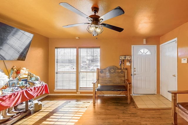 entryway with ceiling fan and light hardwood / wood-style flooring