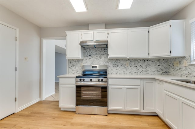 kitchen with stainless steel range with electric cooktop, tasteful backsplash, and white cabinetry