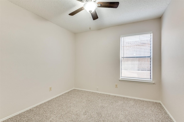 carpeted empty room featuring a textured ceiling and ceiling fan