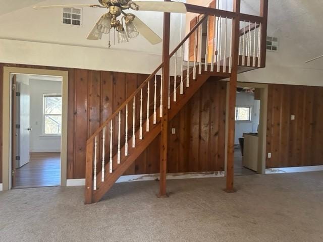 stairs featuring carpet and ceiling fan