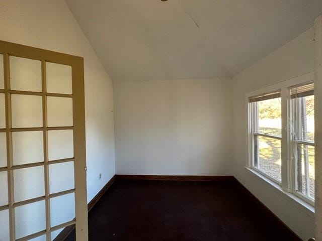 empty room featuring vaulted ceiling