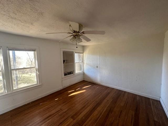 unfurnished room featuring a textured ceiling, dark hardwood / wood-style flooring, and ceiling fan