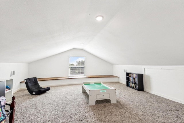 recreation room featuring carpet flooring and vaulted ceiling