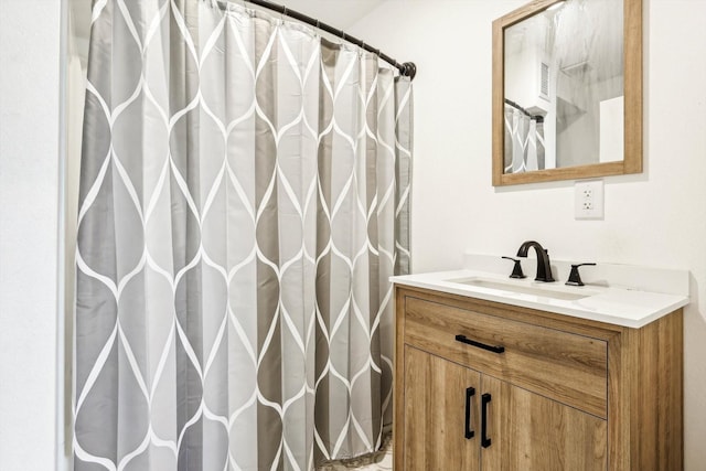 bathroom featuring a shower with curtain and vanity