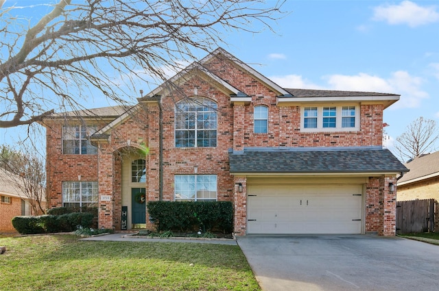 view of front of property featuring a front lawn and a garage