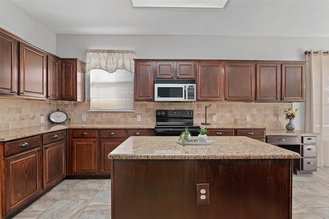 kitchen with electric range, light stone countertops, a center island, and decorative backsplash