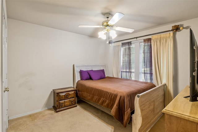 bedroom featuring light colored carpet and ceiling fan