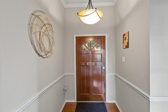 doorway to outside with hardwood / wood-style flooring and ornamental molding