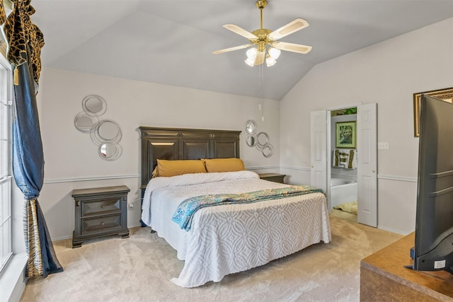 bedroom featuring light colored carpet, vaulted ceiling, and ceiling fan