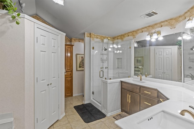 bathroom featuring vanity, tile patterned flooring, and a shower with shower door