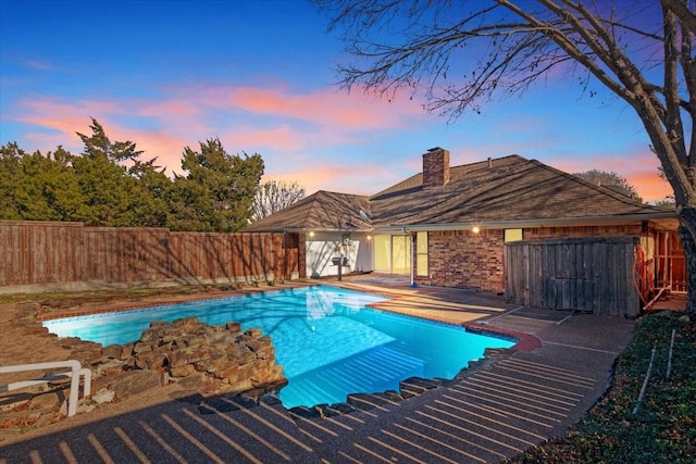 view of pool at dusk