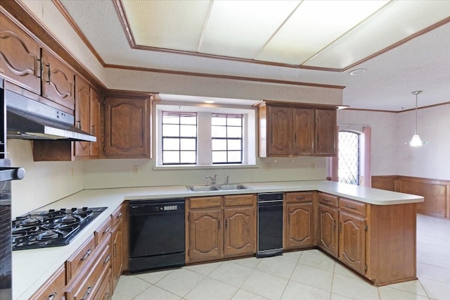 kitchen with kitchen peninsula, ornamental molding, sink, black appliances, and decorative light fixtures