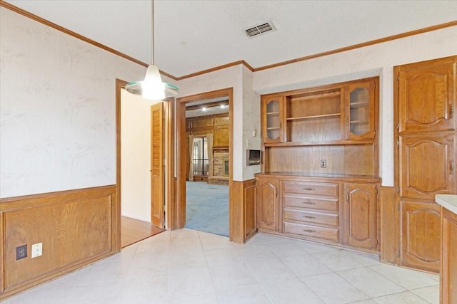 dining area featuring crown molding and a textured ceiling