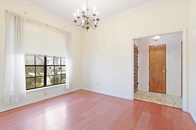 unfurnished room featuring hardwood / wood-style flooring, crown molding, and an inviting chandelier