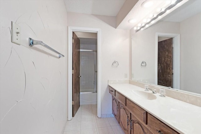 bathroom featuring tile patterned floors, vanity, a textured ceiling, and combined bath / shower with glass door