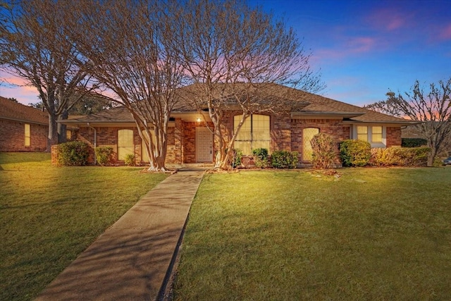 ranch-style house with a yard