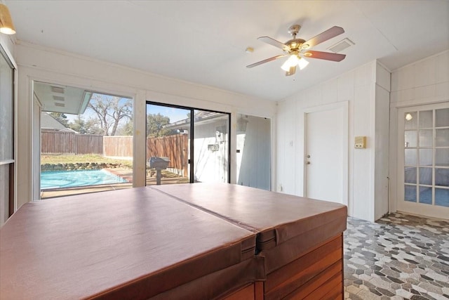 interior space with ceiling fan and vaulted ceiling