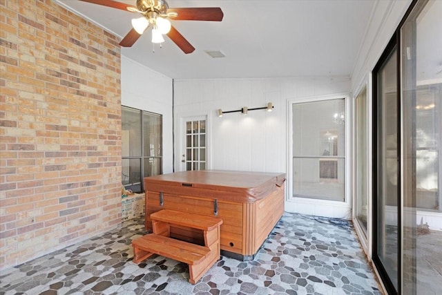 interior space featuring ceiling fan and a hot tub