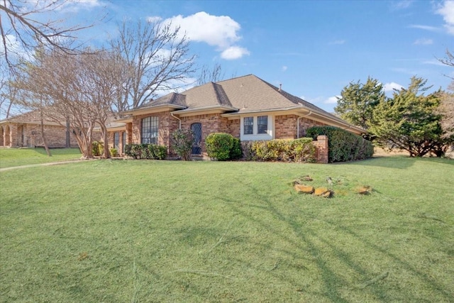 ranch-style home featuring a front yard