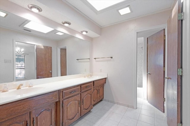 bathroom with tile patterned floors, crown molding, and vanity