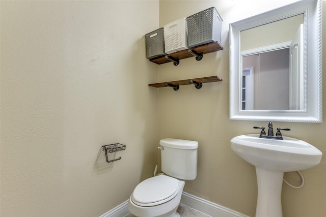 bathroom with toilet and sink