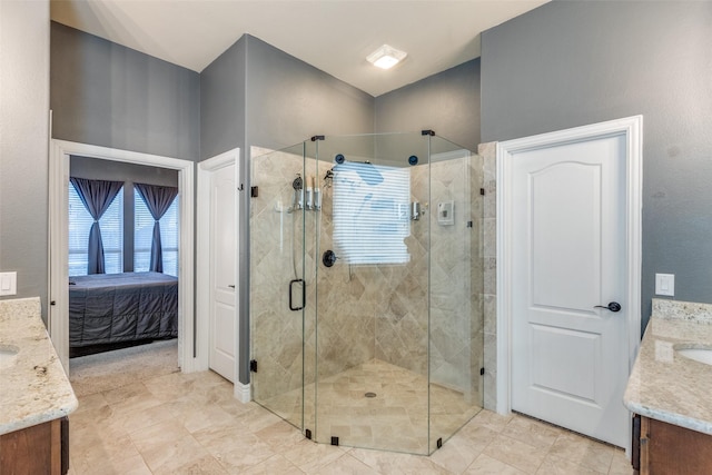 bathroom with a shower with shower door and vanity