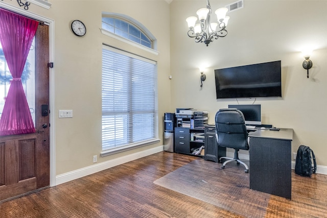 home office featuring an inviting chandelier, a wealth of natural light, and dark wood-type flooring