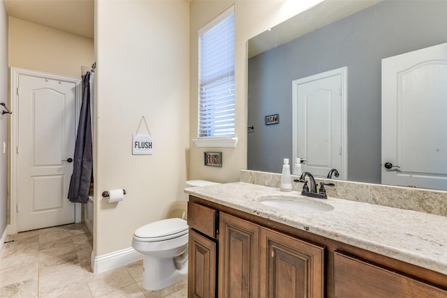 bathroom featuring tile patterned flooring, vanity, and toilet