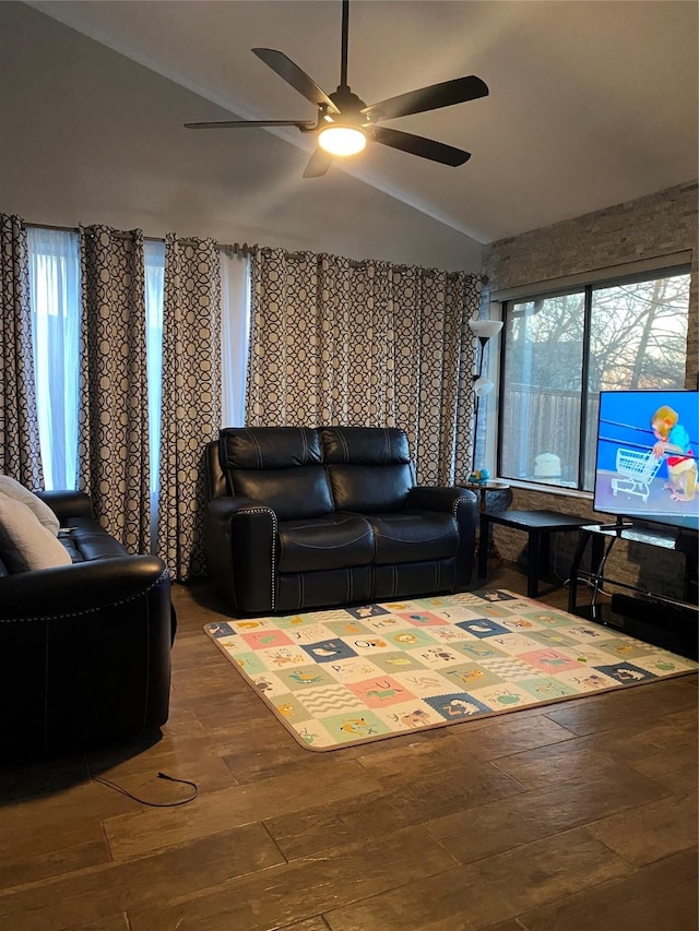 living room featuring lofted ceiling, hardwood / wood-style flooring, and ceiling fan