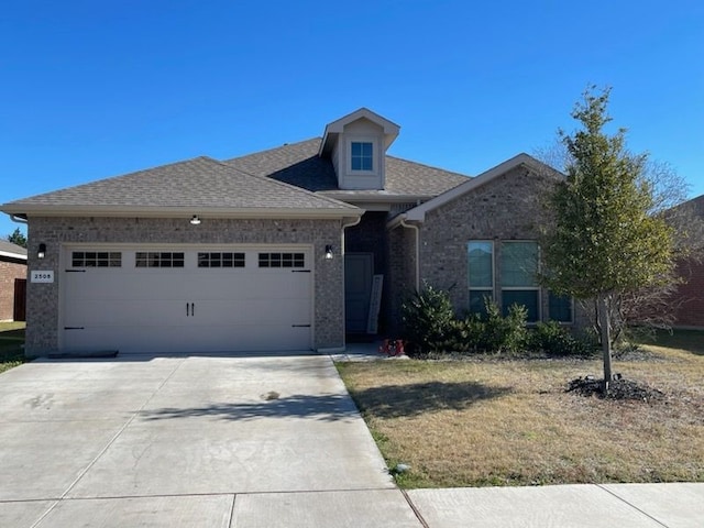 view of front of house with a front lawn and a garage