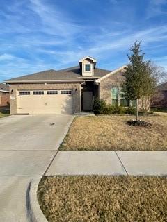 view of front of property with a front yard and a garage