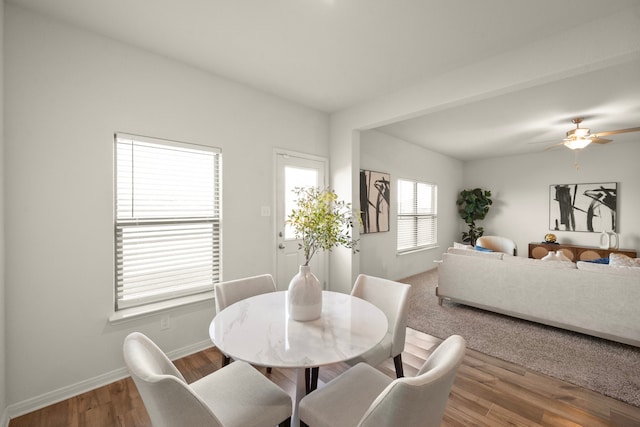 dining space with wood-type flooring and ceiling fan