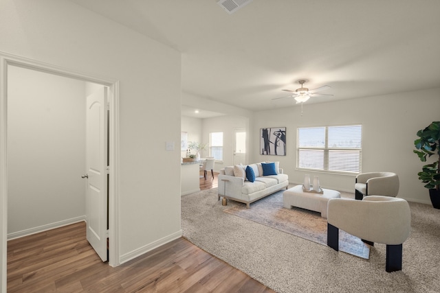 living room with ceiling fan and hardwood / wood-style floors