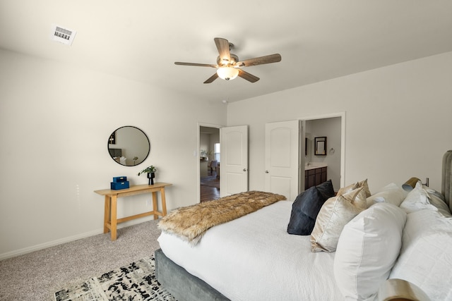 carpeted bedroom featuring ensuite bath and ceiling fan