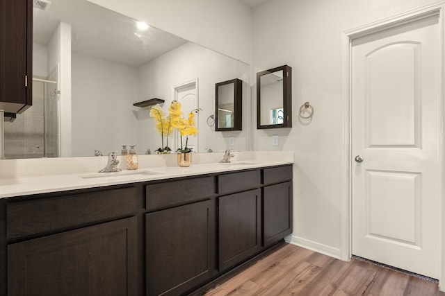 bathroom with vanity, an enclosed shower, and wood-type flooring