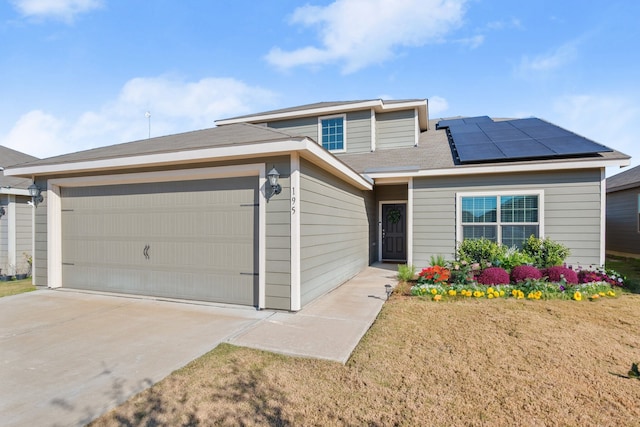 view of front of home featuring solar panels and a garage