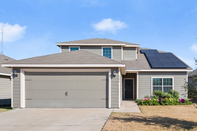 view of front of house featuring a garage and solar panels