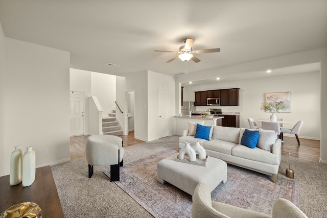 living room with ceiling fan and hardwood / wood-style floors