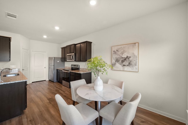 dining space featuring dark hardwood / wood-style floors and sink