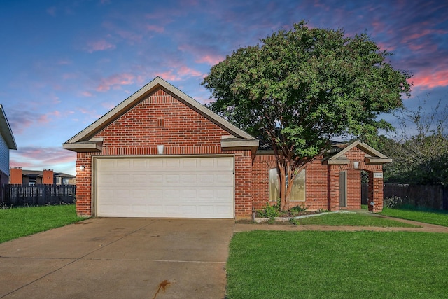 view of front property featuring a lawn and a garage