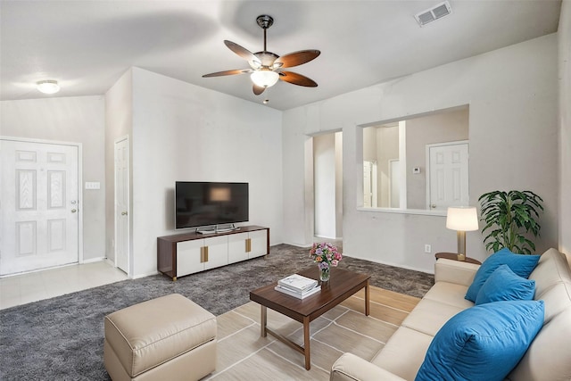 living room featuring carpet and ceiling fan