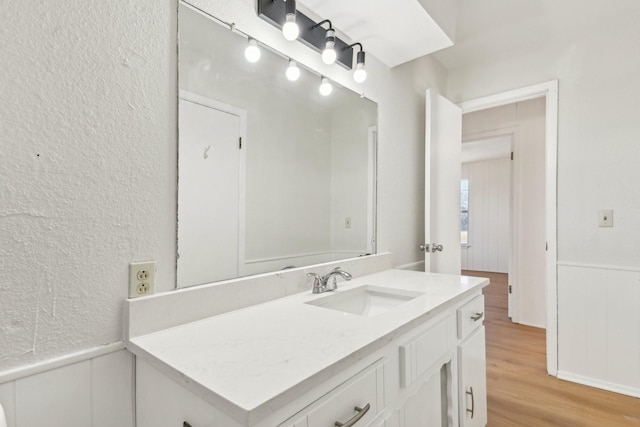 bathroom with hardwood / wood-style floors and vanity