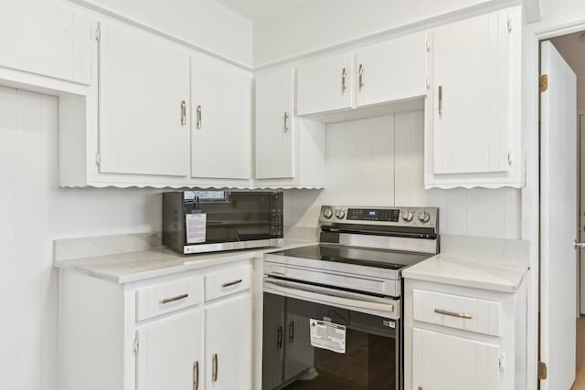 kitchen with appliances with stainless steel finishes and white cabinetry