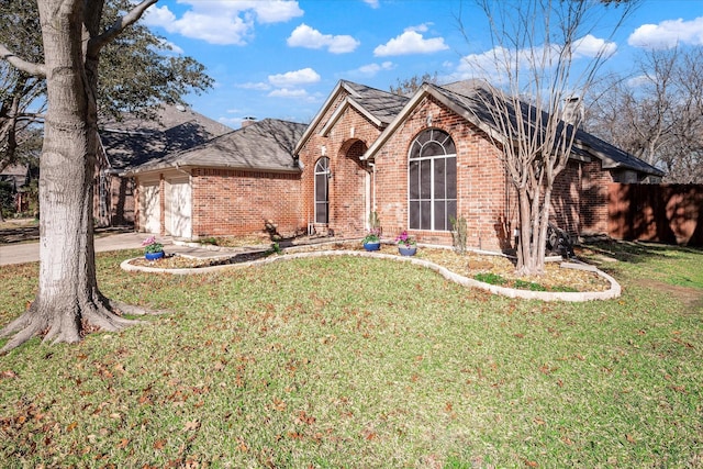 view of front of house with a garage and a front lawn