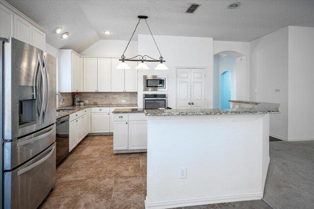 kitchen featuring white cabinetry, a center island, stainless steel appliances, tasteful backsplash, and decorative light fixtures