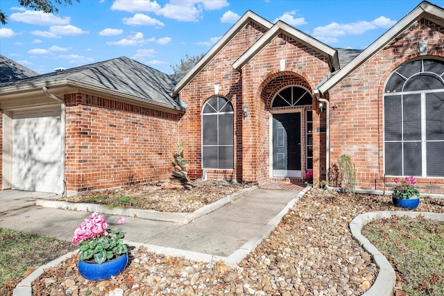 doorway to property with a garage